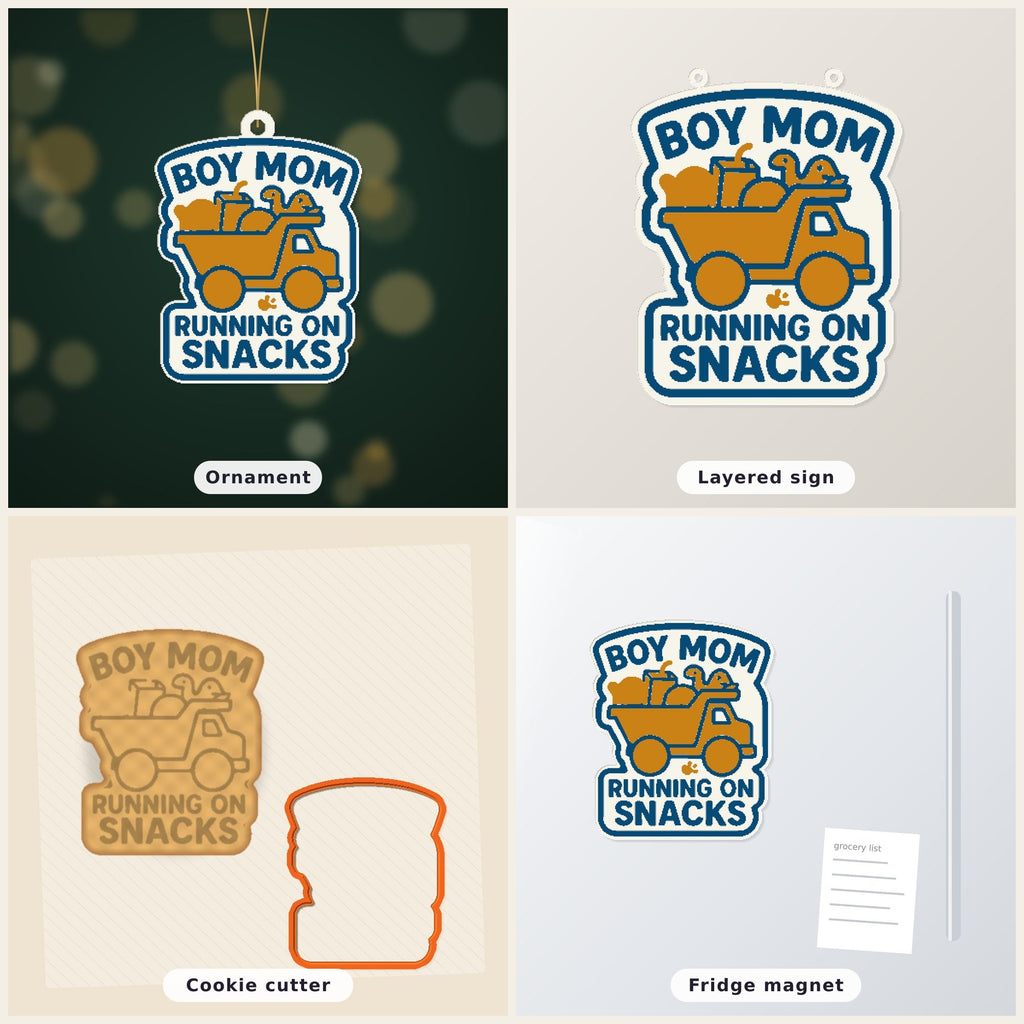 Round-cornered ornament with a blue border and the text Boy Mom Running On Snacks above an orange toy dump truck carrying a teddy bear, a juice cup, a ball and a dinosaur, hanging on a dark green bokeh background.