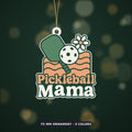 Retro Pickleball Mama ornament with a green paddle, white ball, daisy and peach wavy lines on a dark green blurred background, labeled 75 mm ornament, 4 colors.