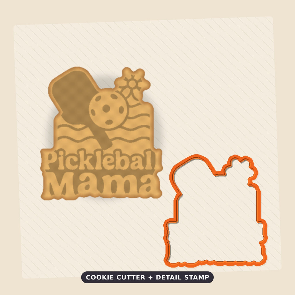 Retro Pickleball Mama ornament with a green paddle, white ball, daisy and peach wavy lines on a dark green blurred background, labeled 75 mm ornament, 4 colors.