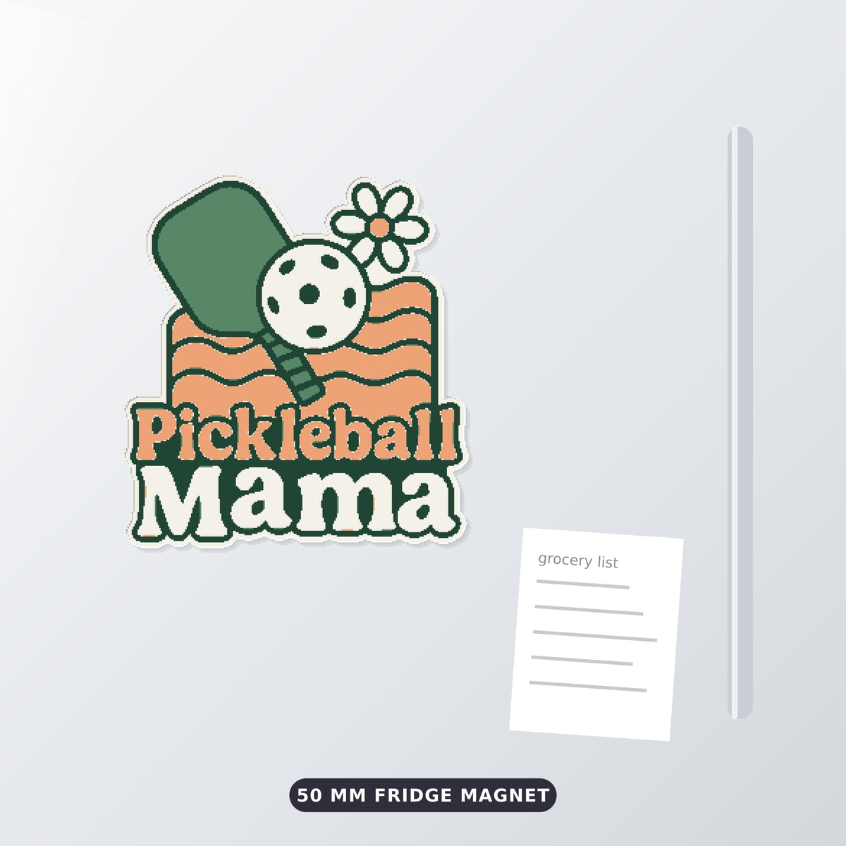Retro Pickleball Mama ornament with a green paddle, white ball, daisy and peach wavy lines on a dark green blurred background, labeled 75 mm ornament, 4 colors.