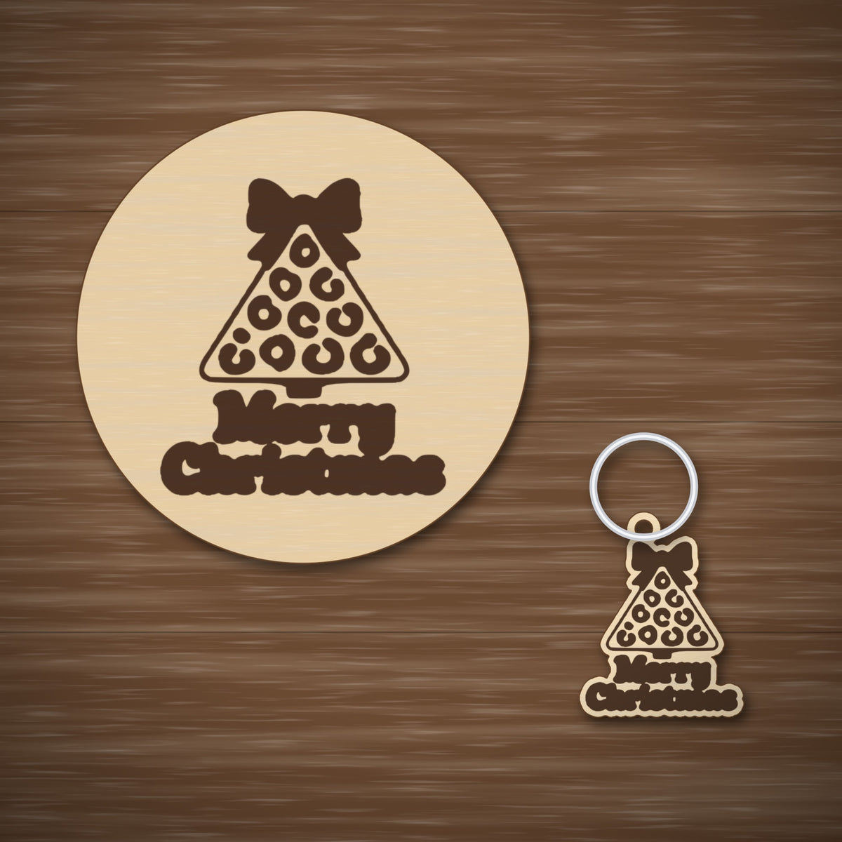 Laser cut wooden Christmas ornament shaped like a leopard print tree with a bow on top and the words Merry Christmas below, hanging against a dark green blurred background.