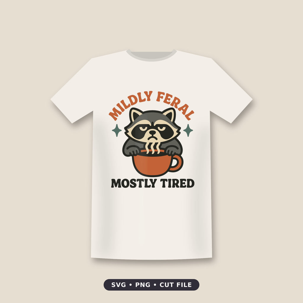 A grumpy gray raccoon with a tired expression peeks over an orange coffee mug with steam rising, under the words Mildly Feral and above the words Mostly Tired.