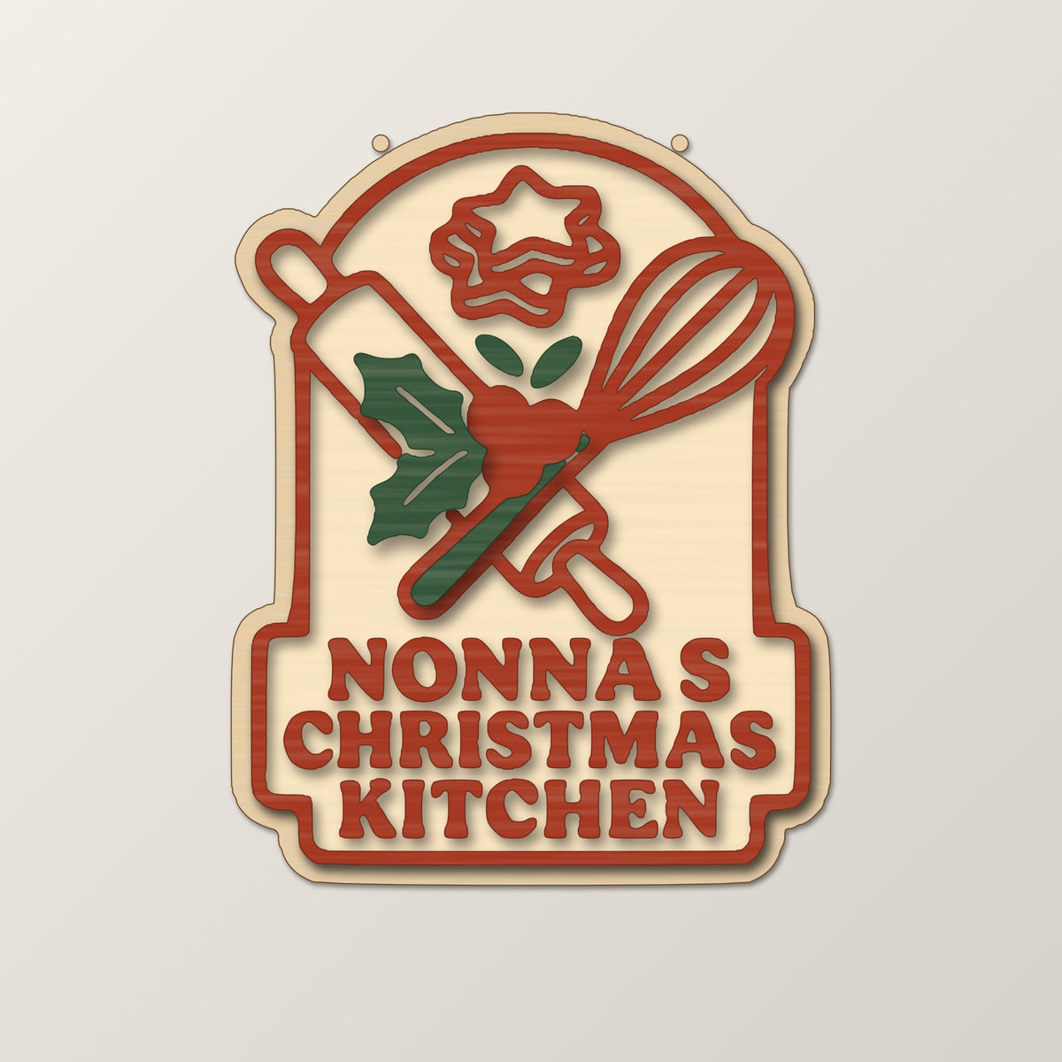 Four mockups of a Nonna's Christmas Kitchen laser project set showing a wooden ornament, a red and green layered sign, a finger-joint keepsake box and a round coaster with a keychain, all with a rolling pin, whisk and holly design.
