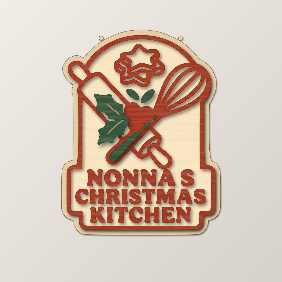 Four mockups of a Nonna's Christmas Kitchen laser project set showing a wooden ornament, a red and green layered sign, a finger-joint keepsake box and a round coaster with a keychain, all with a rolling pin, whisk and holly design.