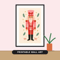 Illustration of a pink and red striped nutcracker with a tall pink hat and bow, surrounded by green pine sprigs, gold stars and candy-striped bows on a cream background.
