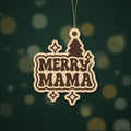 Wooden laser cut ornament engraved with the words Merry Mama in retro lettering, with a Christmas tree and sparkle stars, hanging on a thin cord against a dark green background with golden bokeh lights.