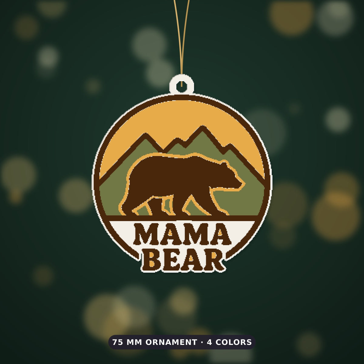 Round retro mama bear ornament showing a brown bear walking in front of green mountains and a yellow sunset, with the words Mama Bear below, hanging on a gold string against a dark green background.