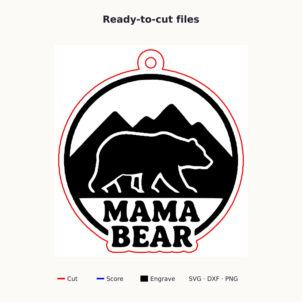 Round wooden laser cut ornament showing a brown bear walking in front of mountains above the words Mama Bear, hanging on a thin cord against a blurred green background with golden lights.