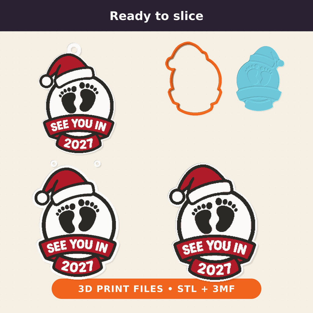 Round white ornament with black baby footprints, a red Santa hat and a red ribbon banner reading See You In 2027, hanging on a gold string against a dark green background.
