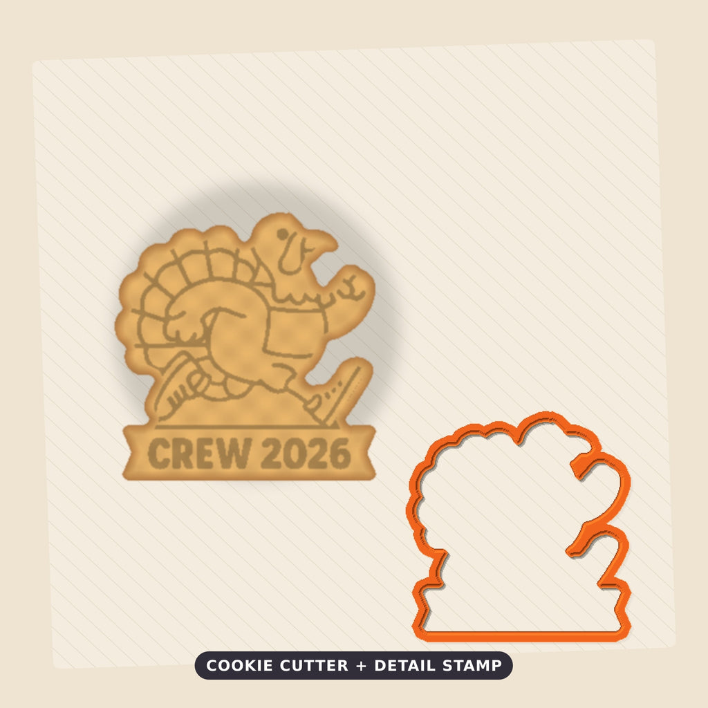 A cartoon turkey in running shoes and a number 26 race bib on a round ornament that reads Turkey Trot at the top and Crew 2026 on a ribbon banner below.