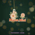 Retro floral ornament with cream and orange wildflowers and rust-red "Mama Mini" lettering, hanging from a gold string against a dark green background, labeled 75 mm ornament, 4 colors.